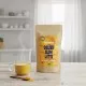Golden Glow Latte por alakú ital csomagolása a The Botanist márkától, 250g kiszerelésben